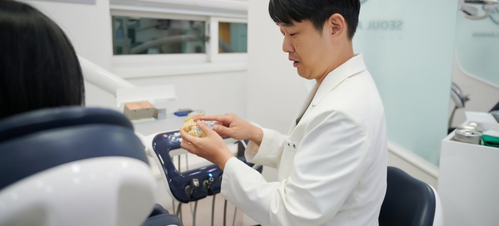 모형으로 수복 방법을 설명하는 임태윤 대표원장